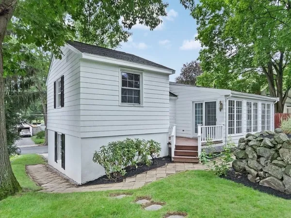 a front view of a house with a garden