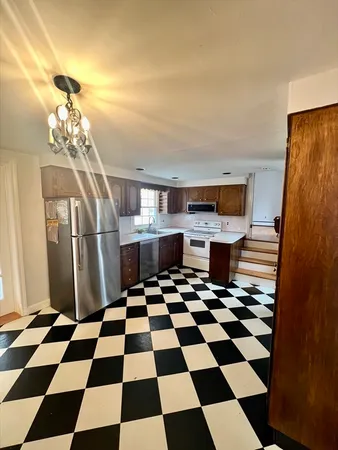 a room with a black white checkered floor and a black white checkered floor with a rug