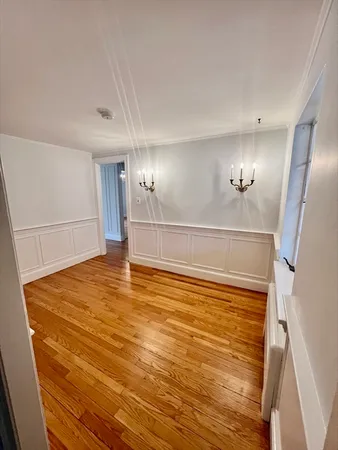 a view of a room with wooden floor