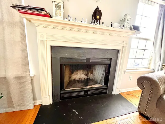 a view of living room with furniture and a fireplace