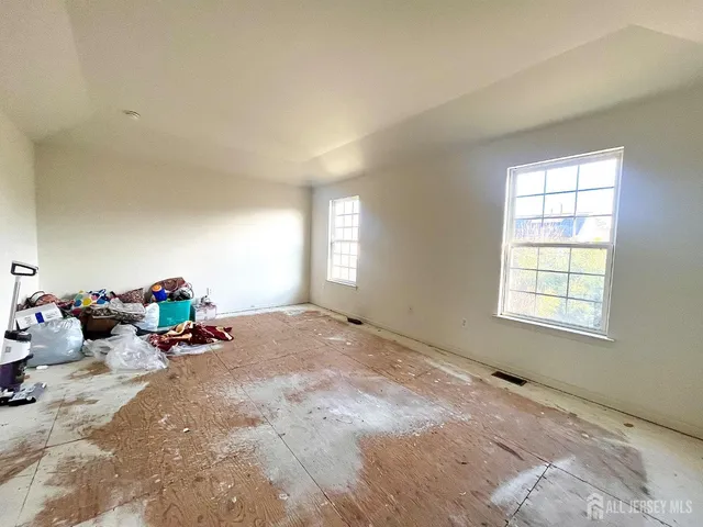 a view of a room with gym equipment and windows