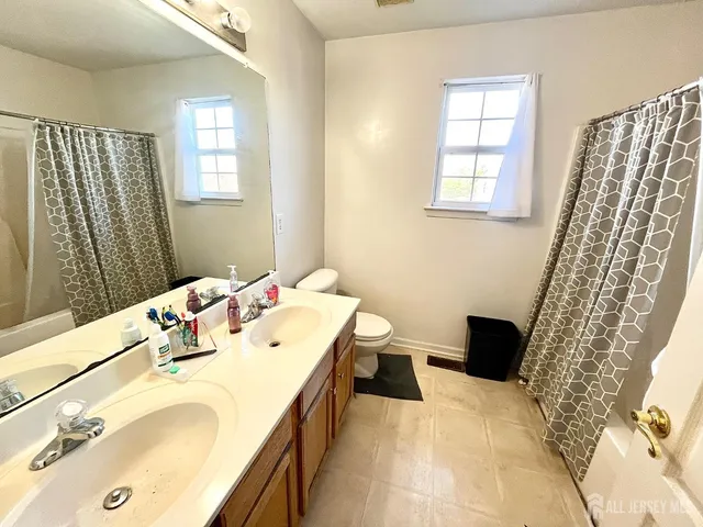 a spacious bedroom with a bed and a dresser