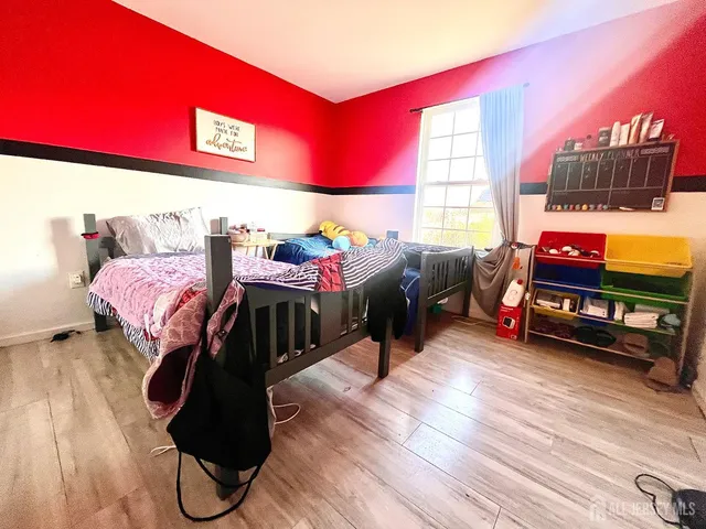 a bedroom with furniture and a window