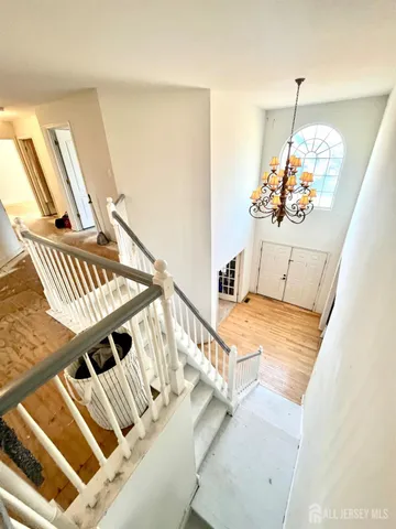 a view of a livingroom with wooden floor and stairs
