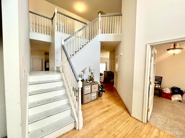 a view of entryway and hall with wooden floor