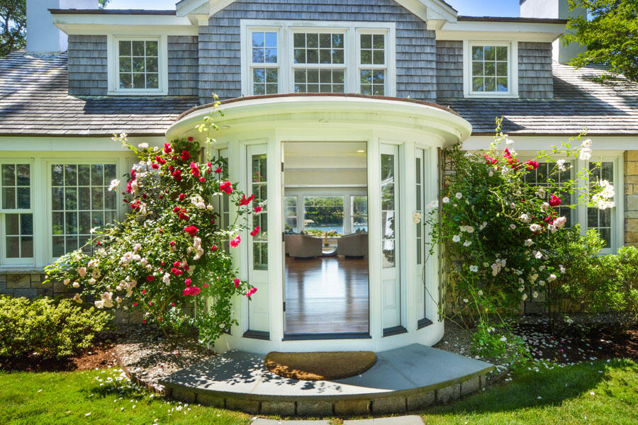 71 Sand Point Osterville, MA 02655 - Photo 10 of 45 a front view of a house with a porch and a fountain