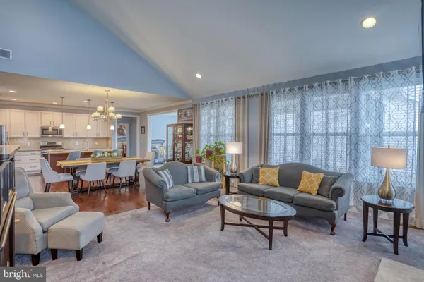 a living room with patio furniture and a potted plant
