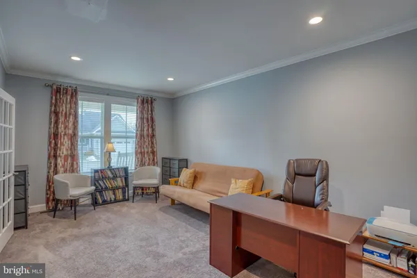 a bedroom with furniture and a large window