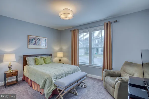 a bedroom with a bed and a television