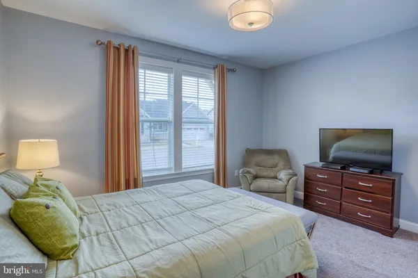 a bedroom with bed and tv