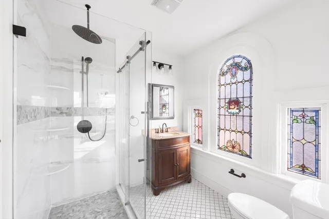 a view of a livingroom with a fireplace a chandelier and wooden floor