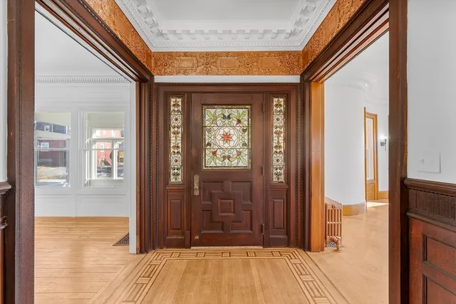 a view of a livingroom with a fireplace and painted walls