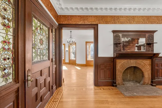 a view of a livingroom with a fireplace a chandelier