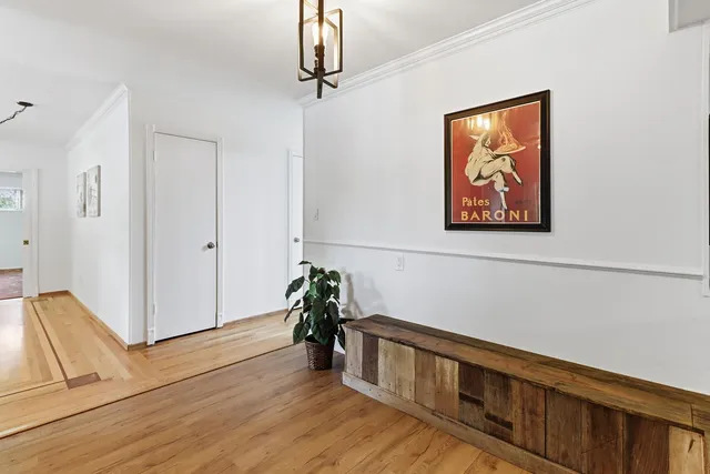 a hallway with wooden floor and windows
