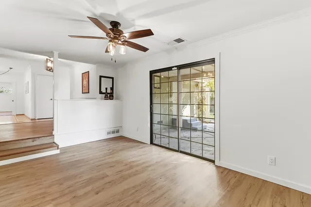 wooden floor in an empty room with a window