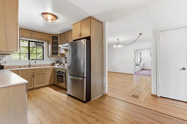 a kitchen with a refrigerator and a sink