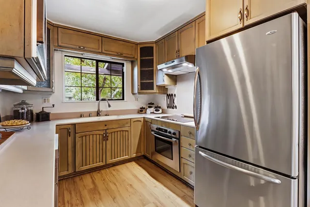 a kitchen with stainless steel appliances a refrigerator sink and microwave