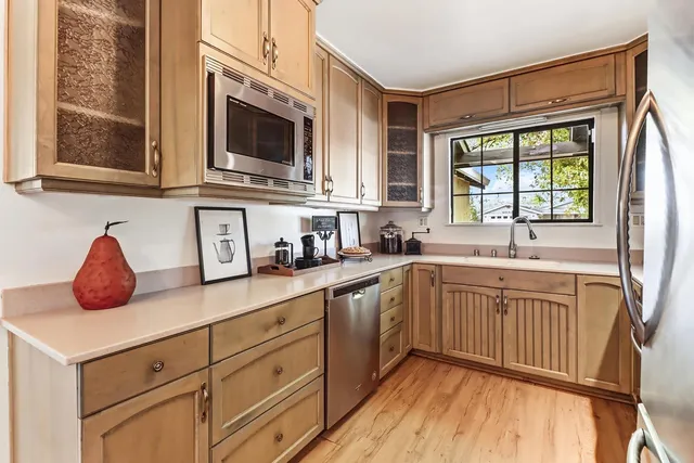a kitchen with stainless steel appliances granite countertop a sink and a stove