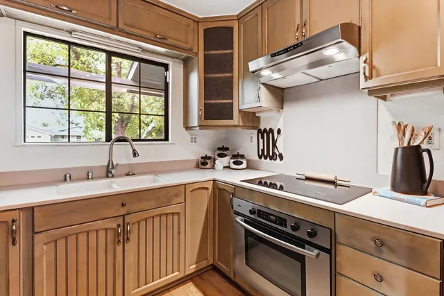 a kitchen with a sink stove and cabinets