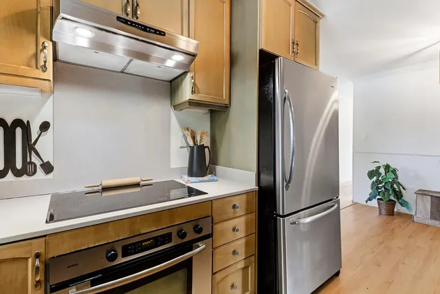 a kitchen with stainless steel appliances a refrigerator and a sink