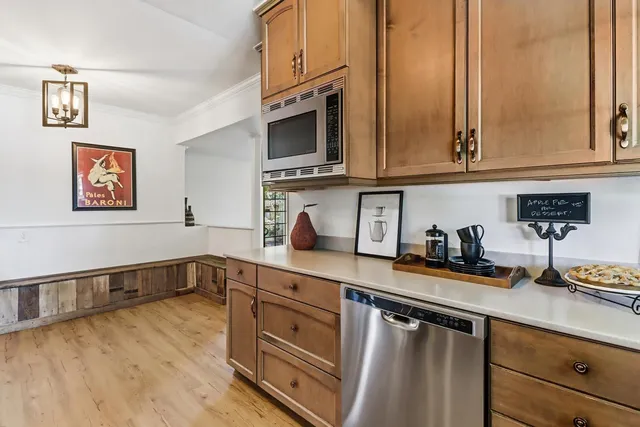 a kitchen with stainless steel appliances granite countertop a sink and cabinets