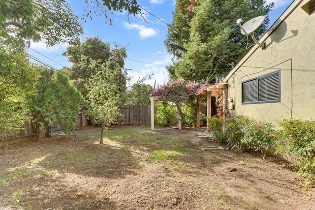 a view of a backyard with large trees