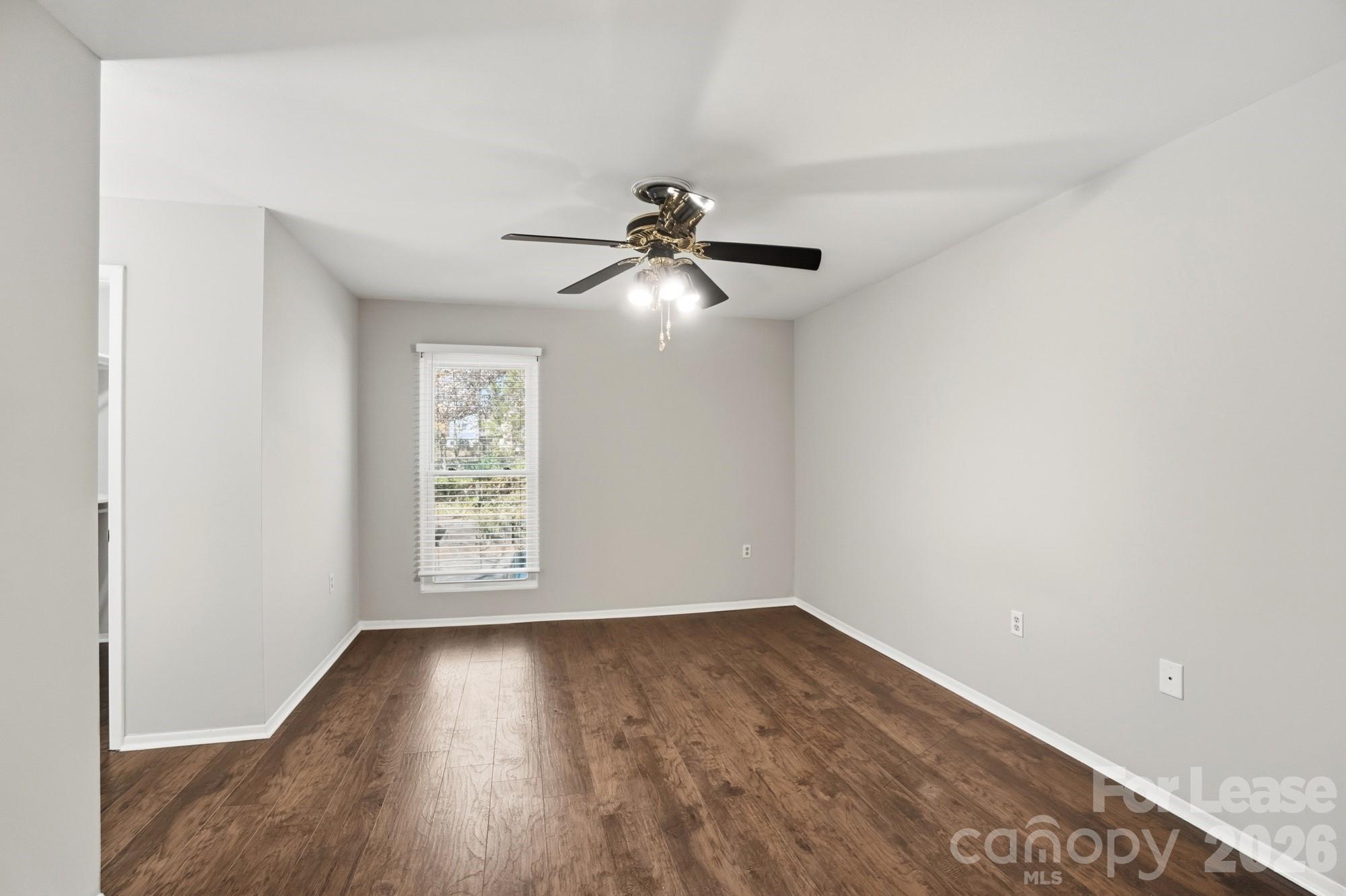 4948 Sardis Road, Unit C Charlotte, NC 28270 - Photo 12 of 25 an empty room with wooden floor and windows