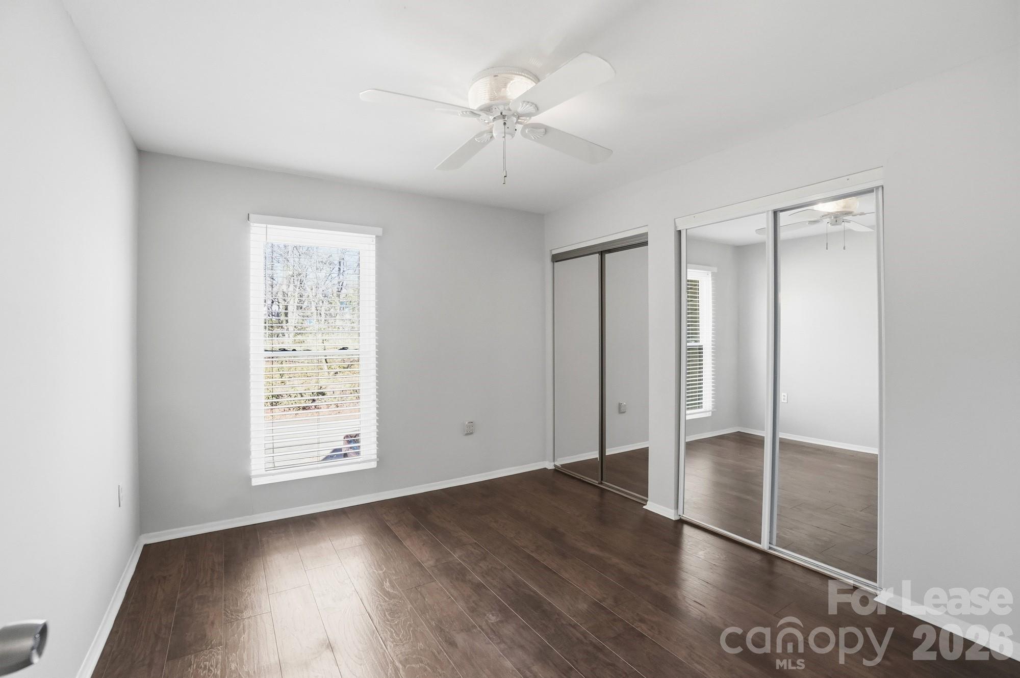 4948 Sardis Road, Unit C Charlotte, NC 28270 - Photo 16 of 25 an empty room with wooden floor closet and windows