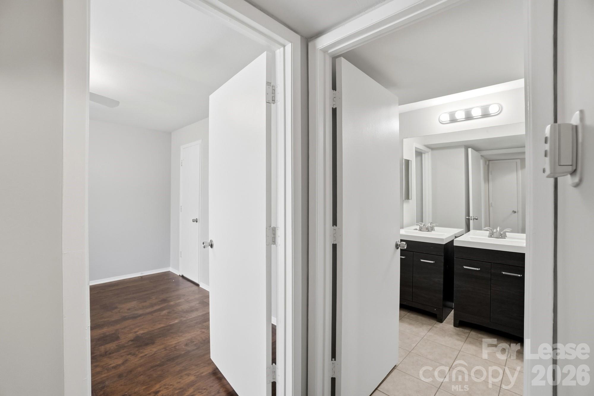 4948 Sardis Road, Unit C Charlotte, NC 28270 - Photo 18 of 25 a view of bathroom with a sink and mirror