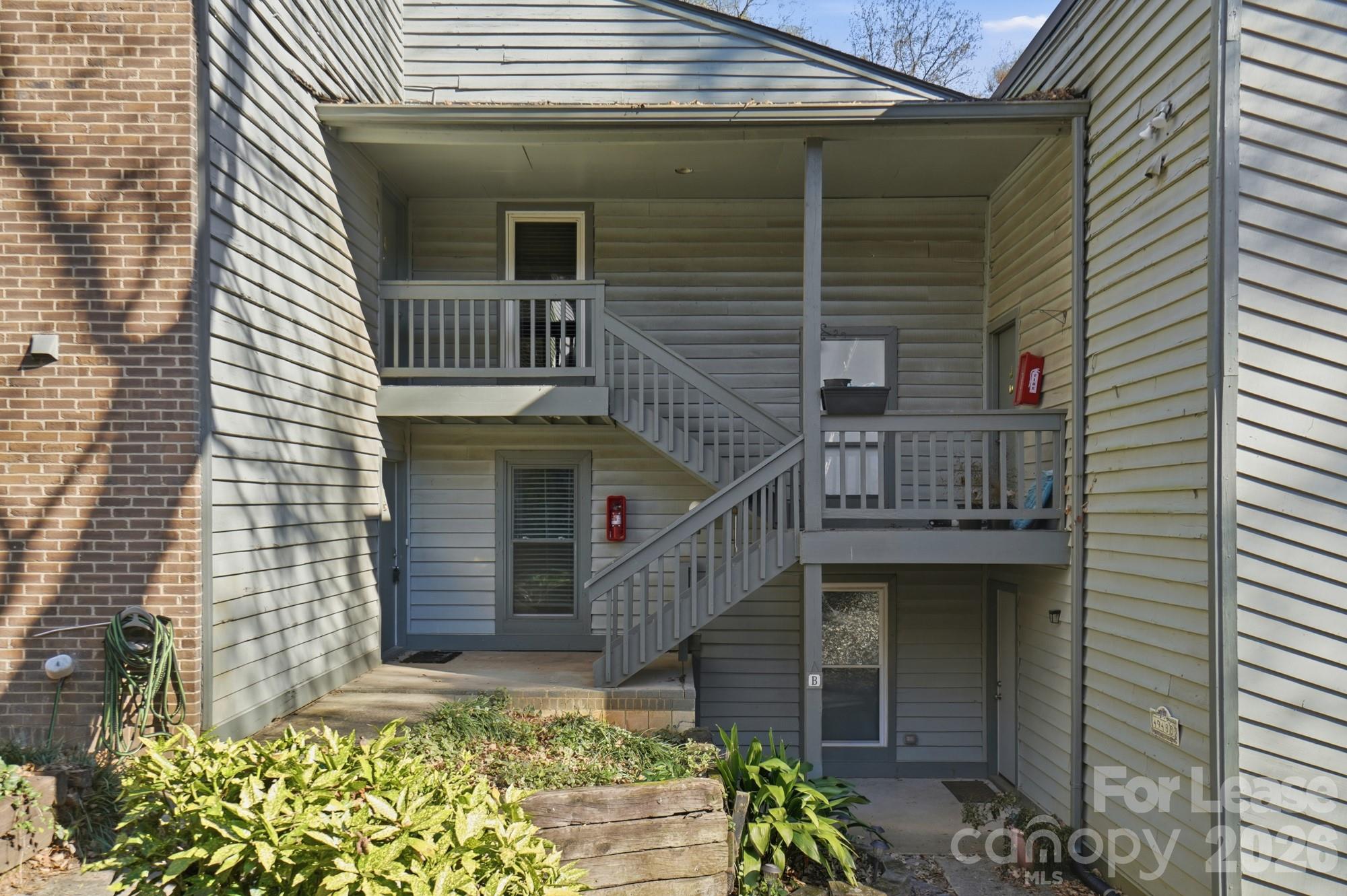 4948 Sardis Road, Unit C Charlotte, NC 28270 - Photo 2 of 25 a front view of a house with a garden