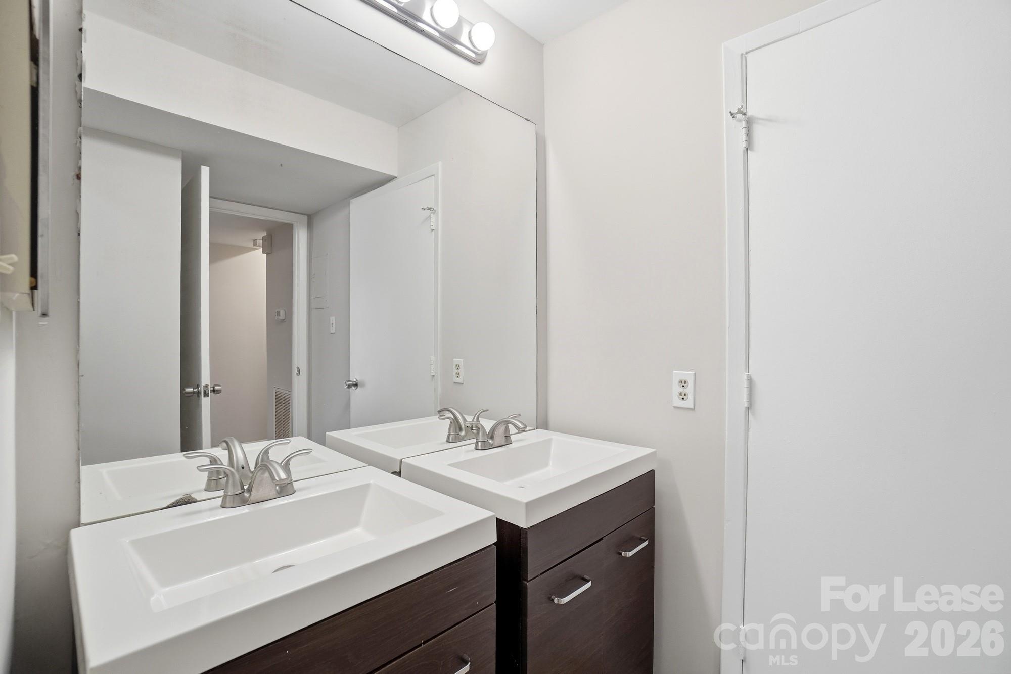 4948 Sardis Road, Unit C Charlotte, NC 28270 - Photo 21 of 25 a bathroom with a sink and a mirror