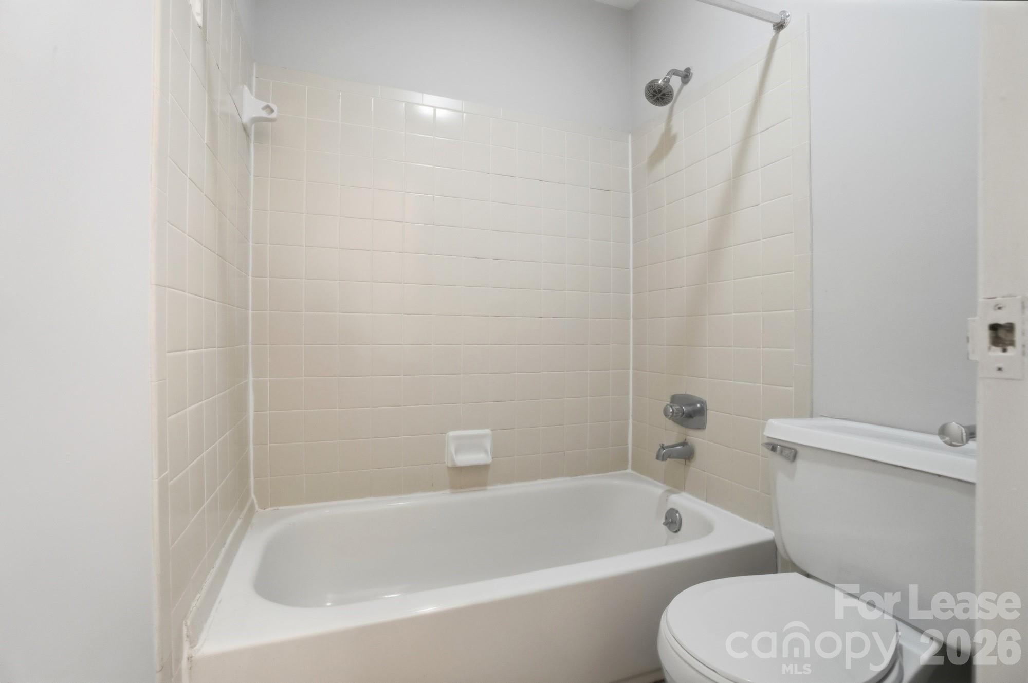 4948 Sardis Road, Unit C Charlotte, NC 28270 - Photo 22 of 25 a white bath tub sitting next to a white toilet and sink
