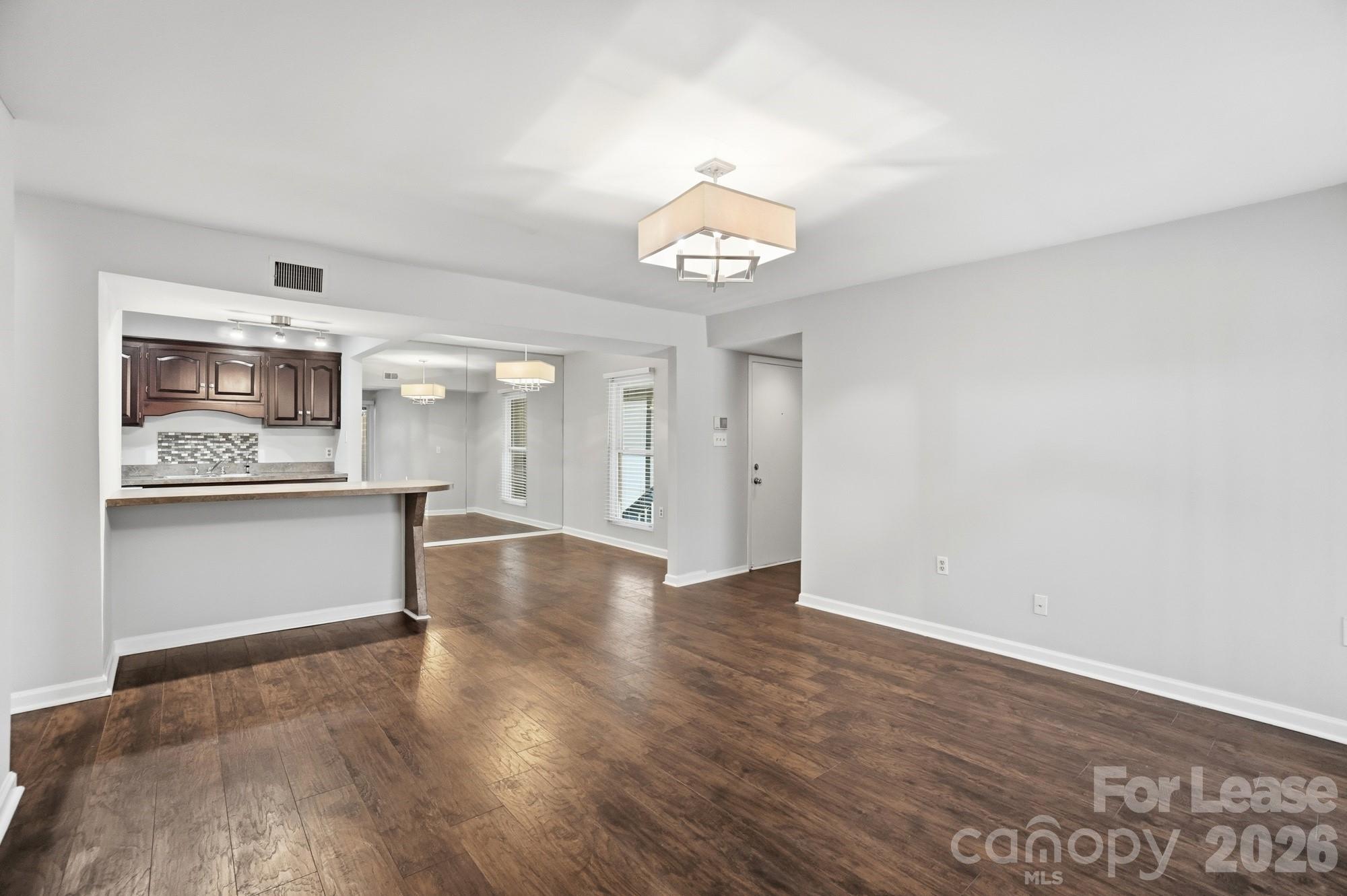 4948 Sardis Road, Unit C Charlotte, NC 28270 - Photo 6 of 25 a view of a kitchen with a dishwasher cabinets and wooden floor