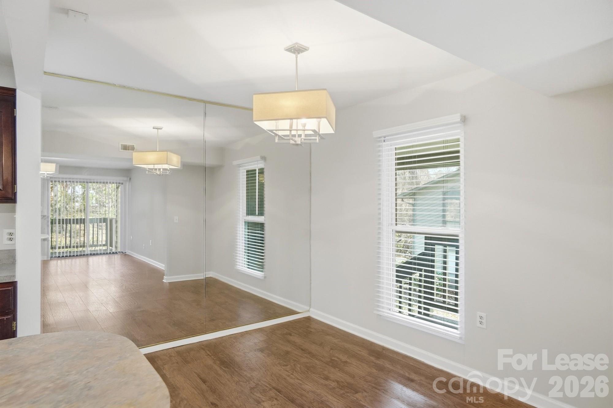 4948 Sardis Road, Unit C Charlotte, NC 28270 - Photo 8 of 25 wooden floor in an empty room with a window