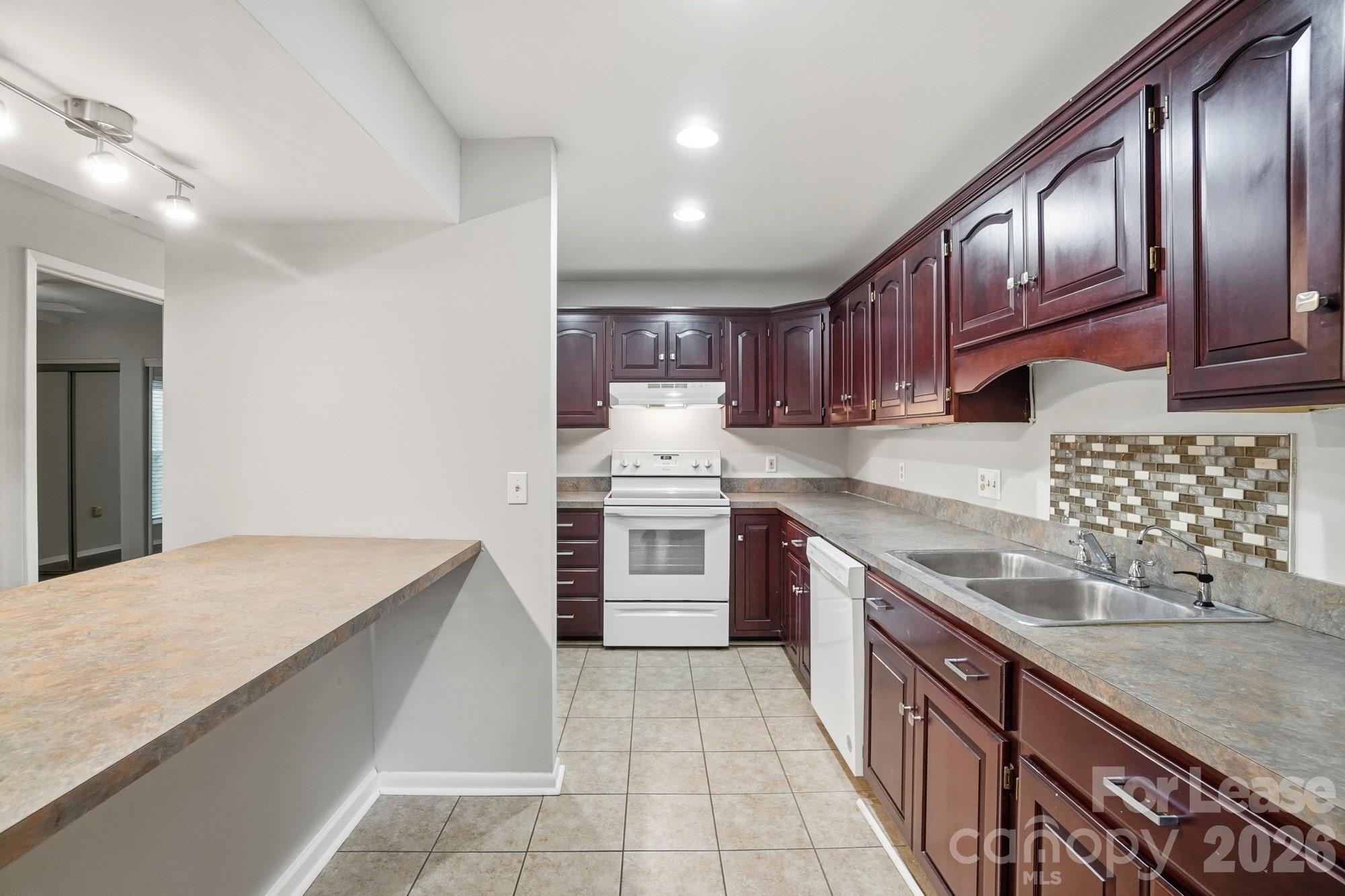 4948 Sardis Road, Unit C Charlotte, NC 28270 - Photo 10 of 25 a kitchen with stainless steel appliances granite countertop a sink stove and oven