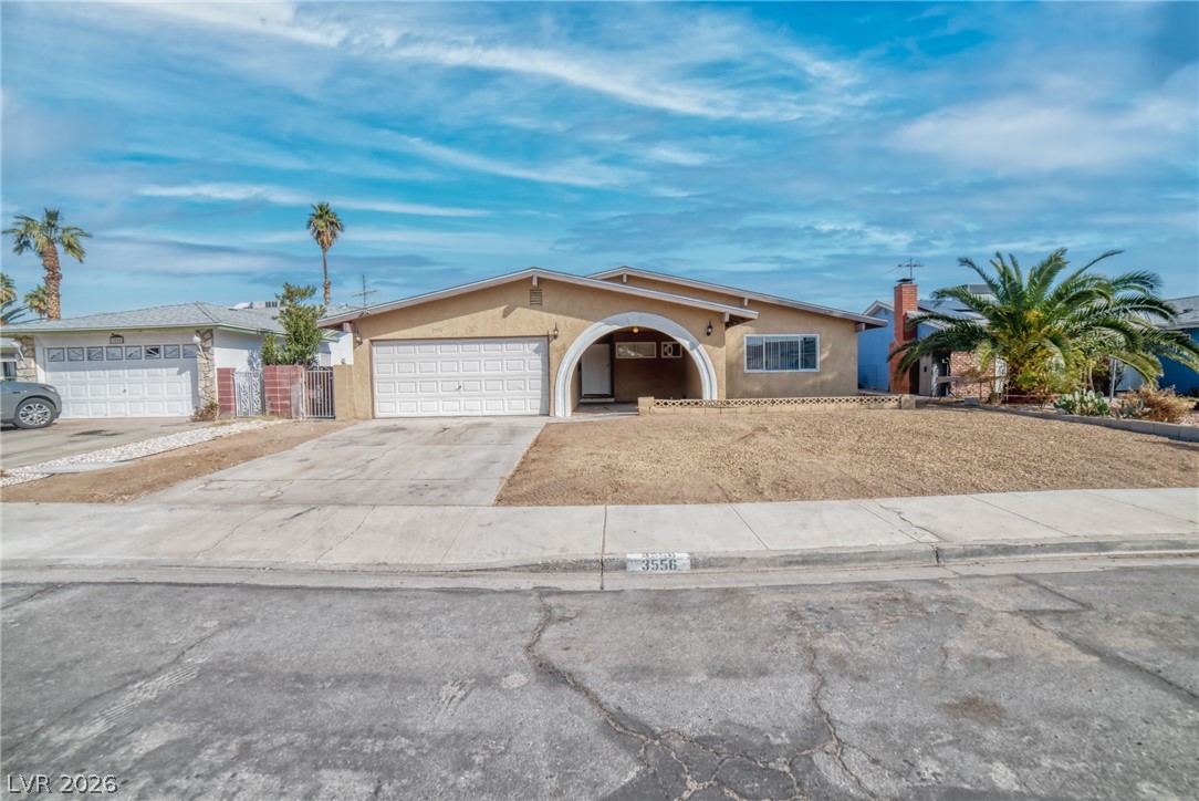 3556 Ruth Drive Las Vegas, NV 89121 - Photo 2 of 21 A modest desert residence with a welcoming arched entry, offering a perfect blend of simplicity and character.
