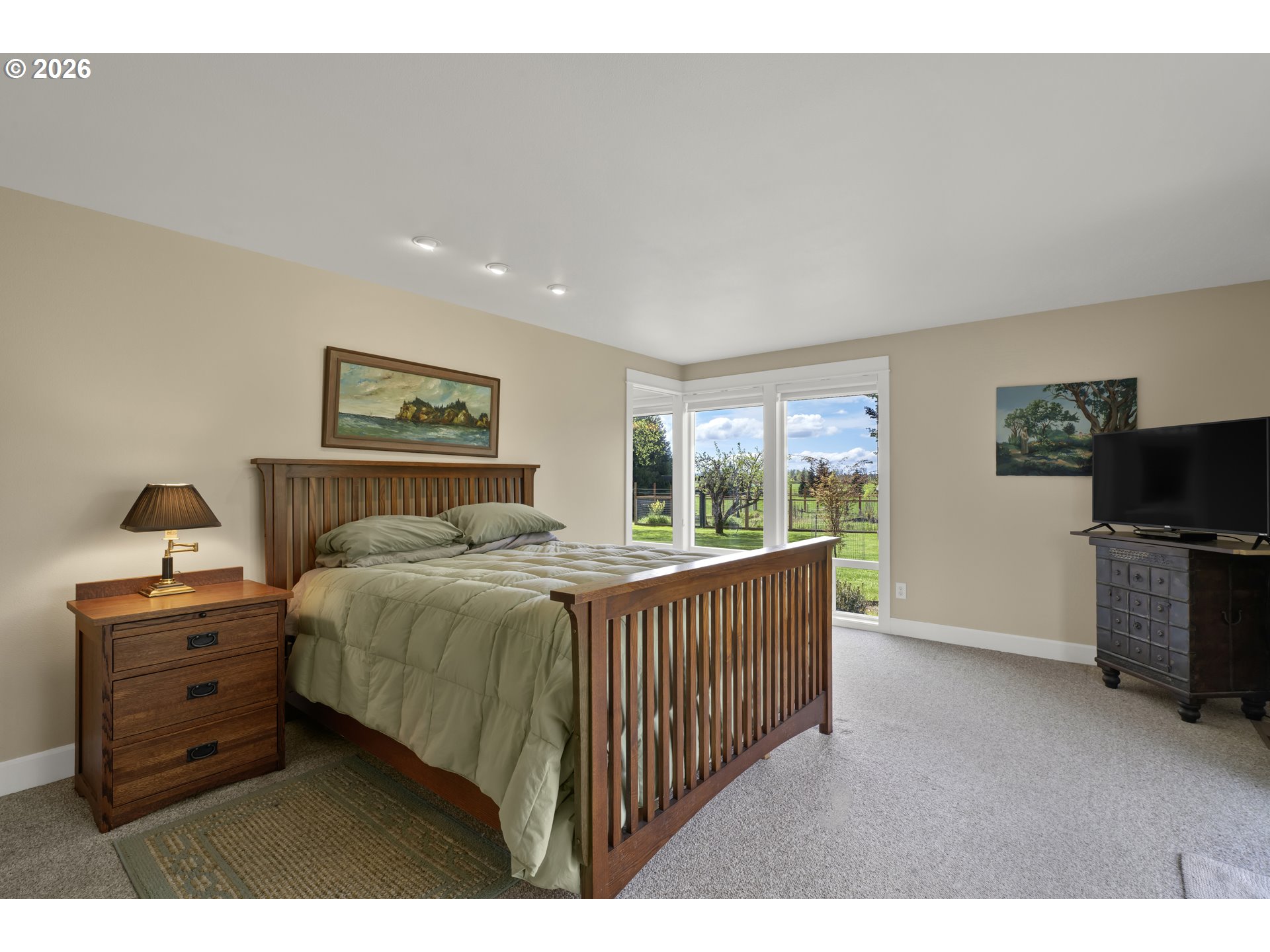 7924 Thurston Road Springfield, OR 97478 - Photo 22 of 45 a bedroom with a bed and a flat tv screen on the dresser