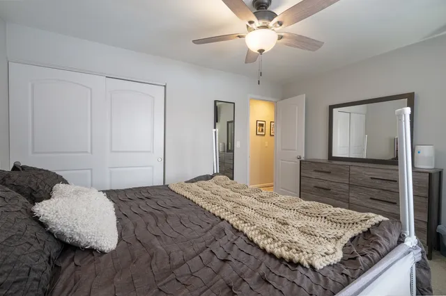 a bedroom with a bed and a chandelier