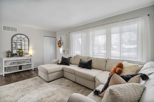 a living room with furniture and a large window