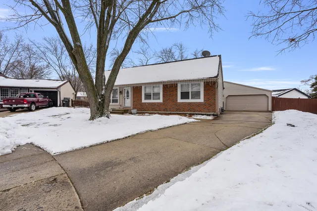 a view of a house with a yard covered in snow