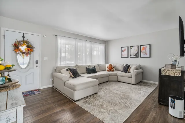a living room with furniture a rug and a flat screen tv