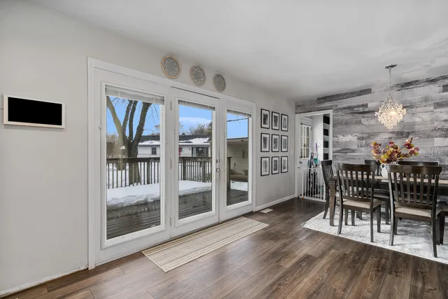a dining room with furniture and wooden floor