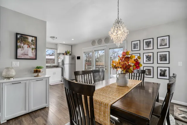 a view of a dining room with furniture wooden floor and chandelier