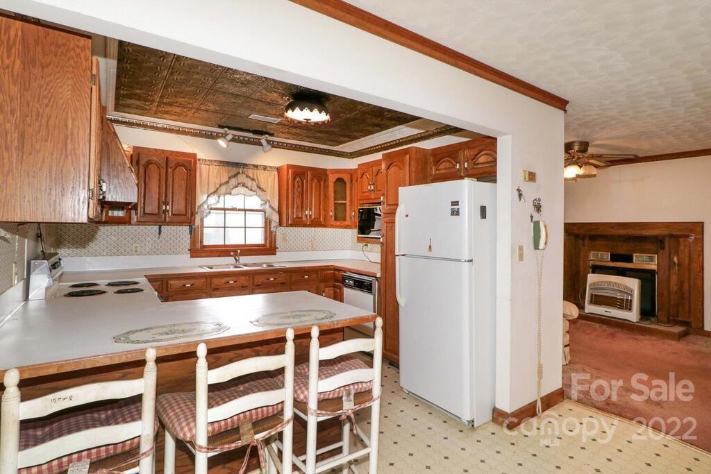 555 Bradshaw Road Salisbury, NC 28147 - Photo 11 of 48 a kitchen with granite countertop a refrigerator and a stove top oven