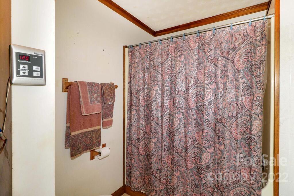 555 Bradshaw Road Salisbury, NC 28147 - Photo 17 of 48 a bathroom with a shower curtain and a window