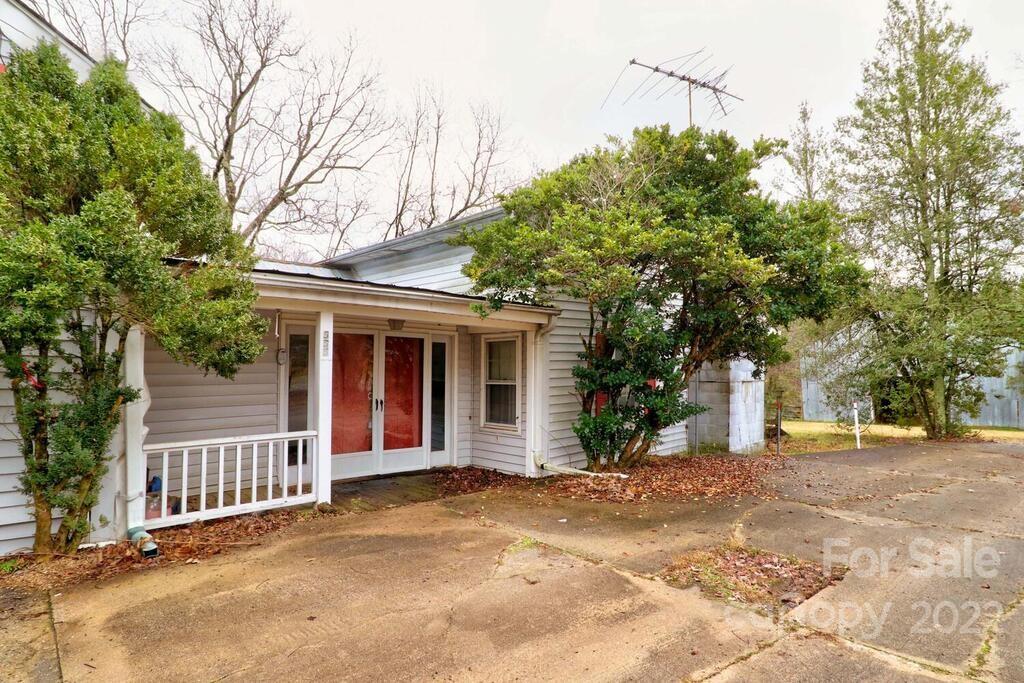 555 Bradshaw Road Salisbury, NC 28147 - Photo 2 of 48 a view of a house with a tree and wooden fence
