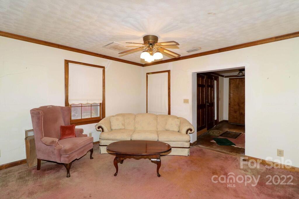 555 Bradshaw Road Salisbury, NC 28147 - Photo 8 of 48 a living room with furniture a chandelier and a window
