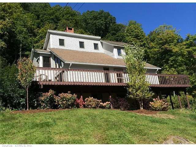 a view of a house with a yard and deck