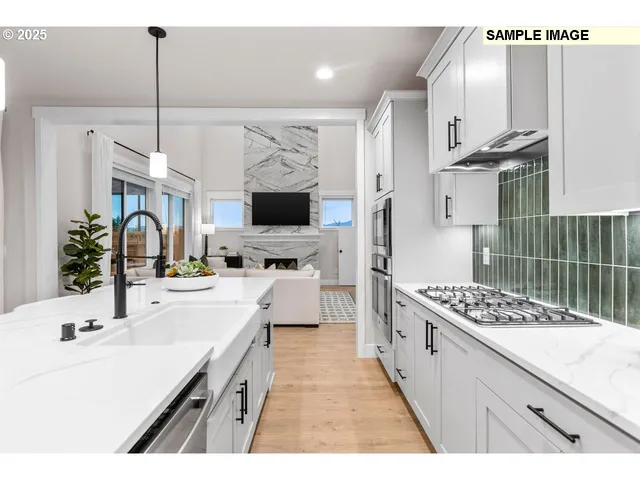 a kitchen with kitchen island stainless steel appliances a sink stove and cabinets