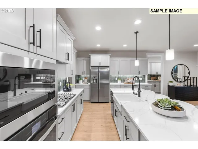a kitchen with kitchen island granite countertop lots of counter top space and stainless steel appliances